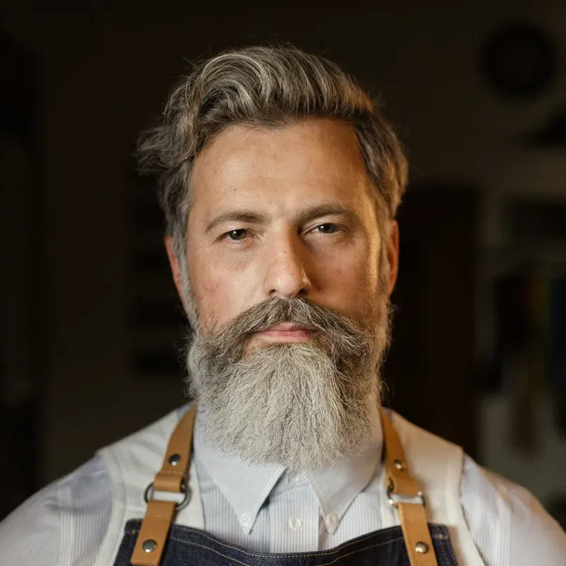 Bearded master barber portrait