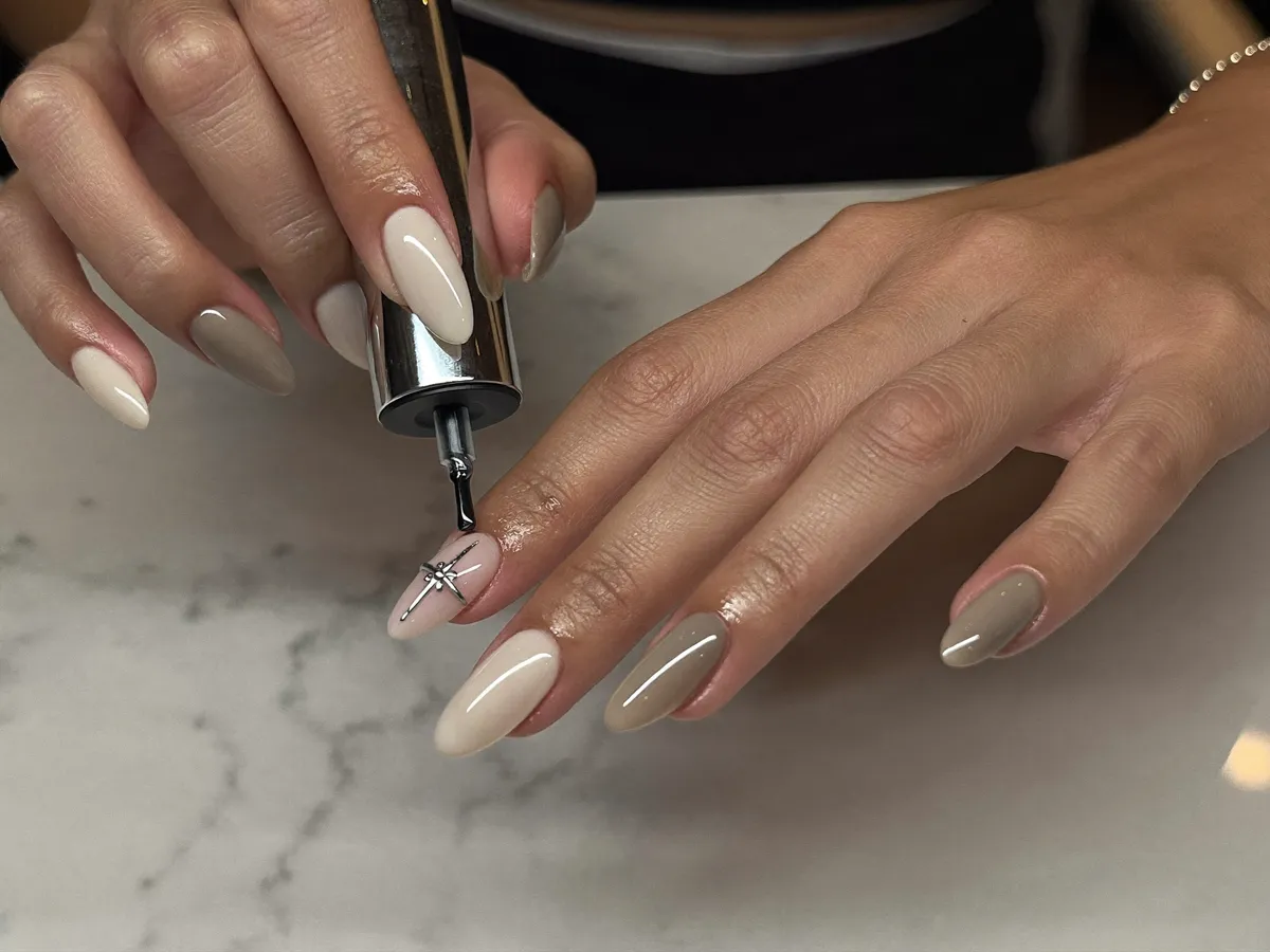 Almond nails in warm neutrals over marble
