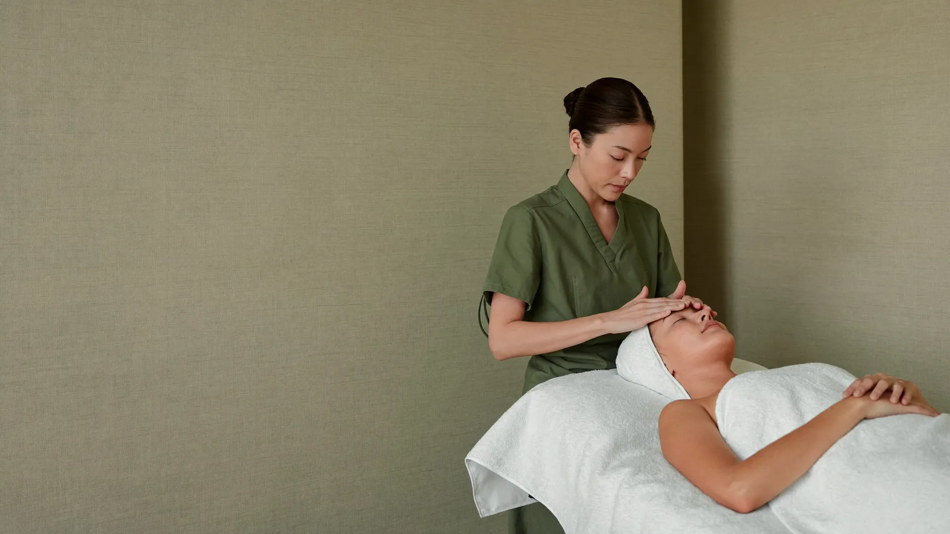 Facial treatment in a linen-walled studio