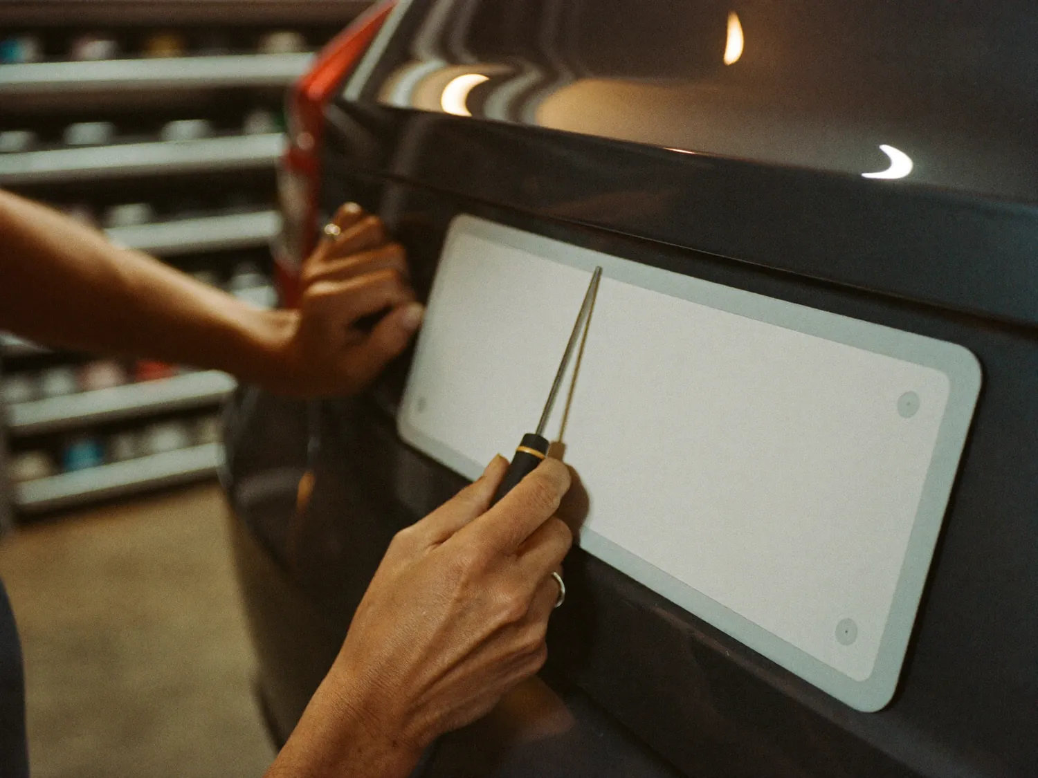 New number plate being fitted to a car